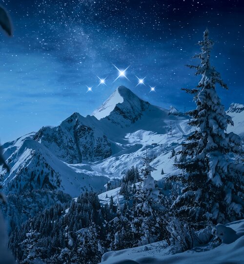 Snowy mountains at night, above five shining stars