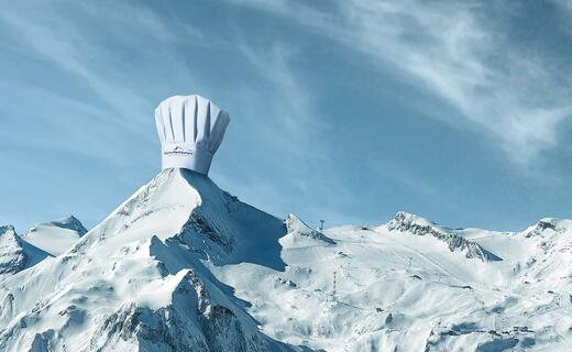 Snow-covered mountain peak with chef's hat under blue sky