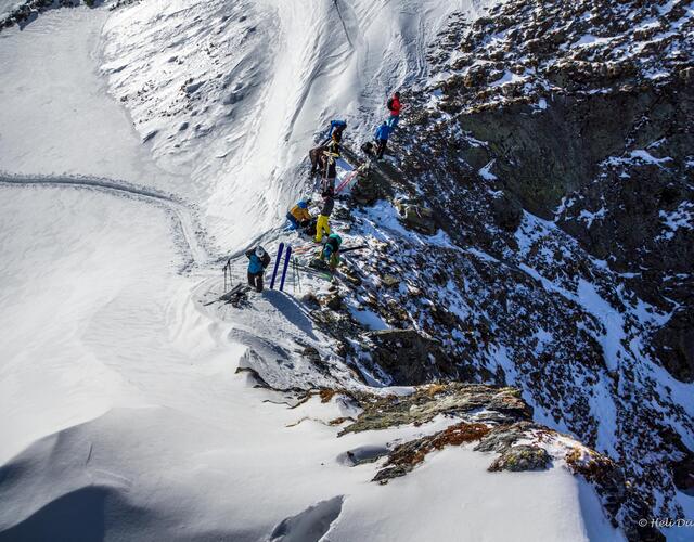 Group of mountaineers on a snow-covered ridge in the mountains