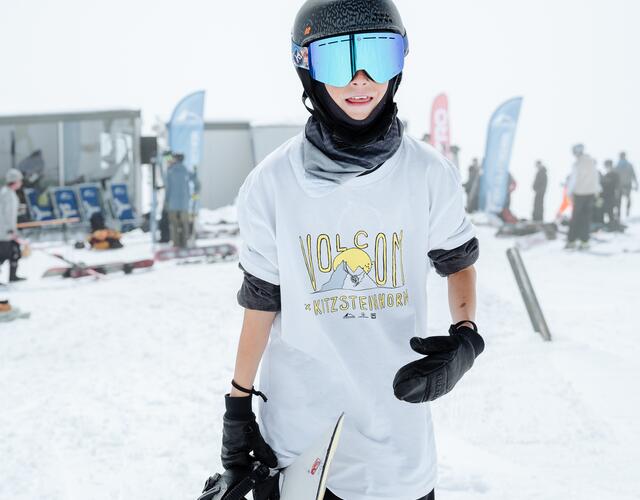 Snowboarder with helmet and blue ski goggles on slope